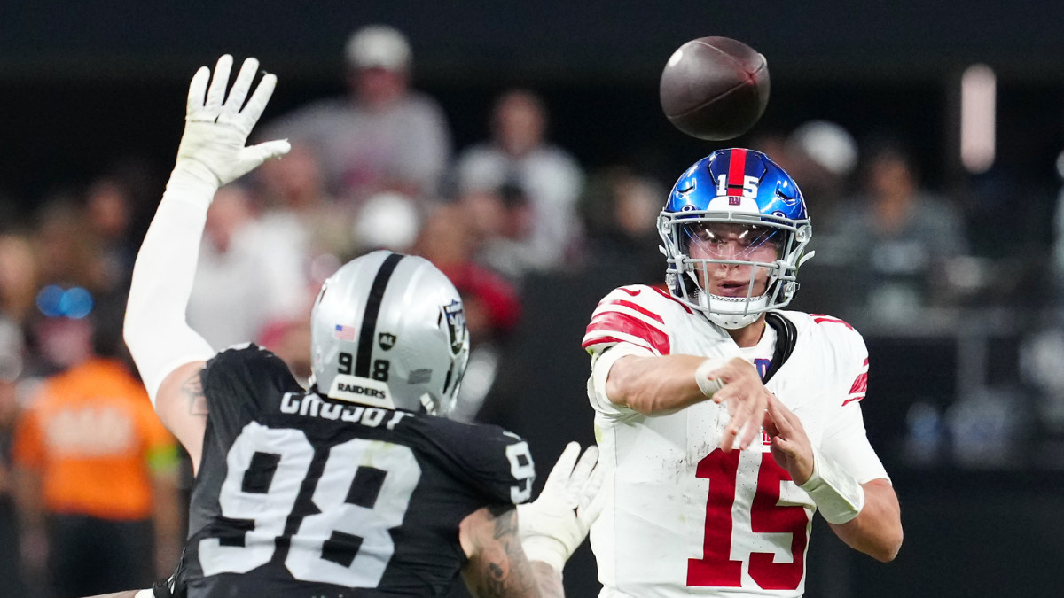 Nov 5, 2023; Paradise, Nevada, USA; New York Giants quarterback Tommy DeVito (15) is pressured by Las Vegas Raiders defensive end Maxx Crosby (98) during the fourth quarter at Allegiant Stadium.